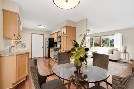 The bright and inviting kitchen is designed for both everyday living and entertaining, featuring abundant cabinetry, granite countertops, and stainless steel appliances