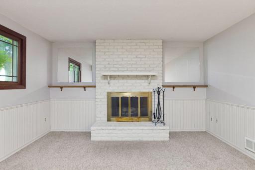 Showcasing a clean, crisp white brick fireplace