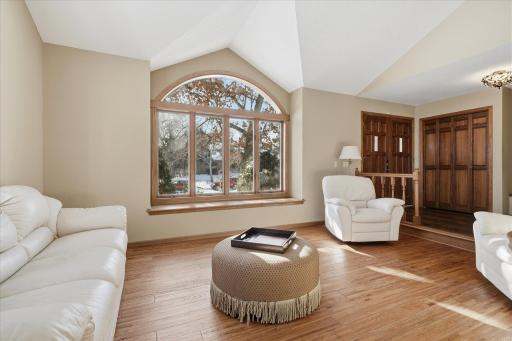 Vaulted open Living Room w/large windows for lots of South exposure sunlight. Beautiful wood flooring and open to both Entry and Formal Dining Room