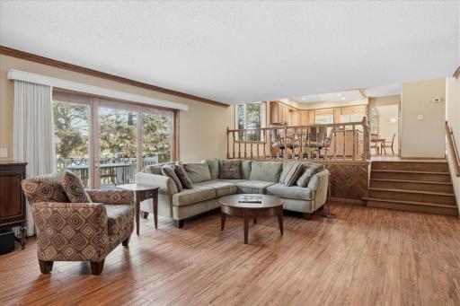Walkout Family Room with wood floors opens to Kitchen and sliders to maint-free deck