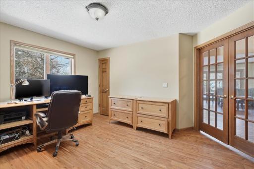 Main Level 3rd Bedroom/Office w/hardwood flooring, French double doors and two closets