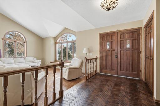 Inviting Entry w/custom wood flooring, large closet and sitting bench