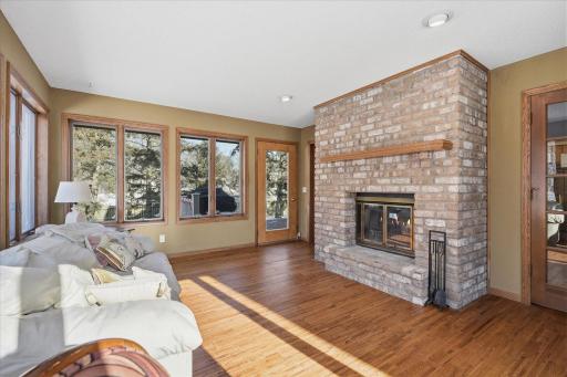 Gorgeous Sunroom w/see thru wood burning fireplace, SW exposure windows, hardwood floors, French doors to Family Room and patio door to deck for great entertaining