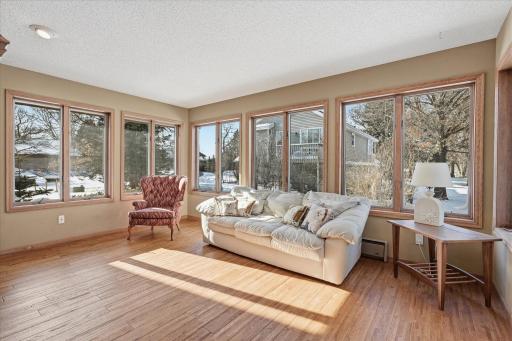 Gorgeous Sunroom w/see thru wood burning fireplace, SW exposure windows, hardwood floors, French doors to Family Room and patio door to deck for great entertaining