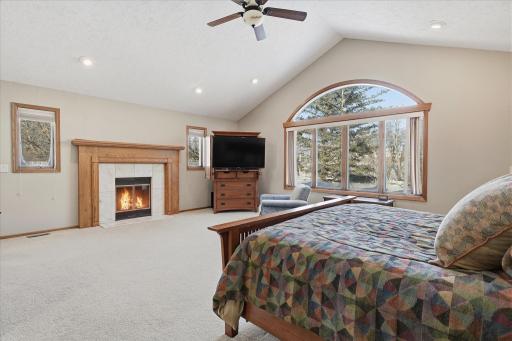 Upper level expansive custom Primary Bedroom features: high vaulted ceiling, huge windows for great views, cozy fireplace, recessed lights and walk-in closet