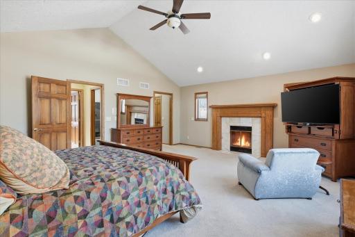 Upper level expansive custom Primary Bedroom features: high vaulted ceiling, huge windows for great views, cozy fireplace, recessed lights and walk-in closet