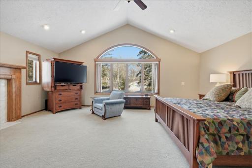 Upper level expansive custom Primary Bedroom features: high vaulted ceiling, huge windows for great views, cozy fireplace, recessed lights and walk-in closet