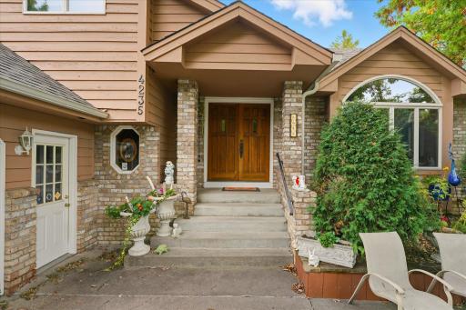Great curb appeal exterior w/front entry porch with brick accents