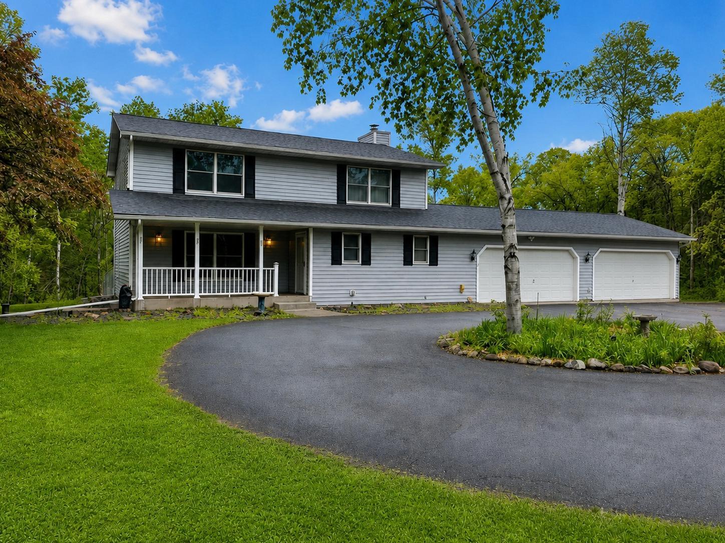 A circular drive and mature trees create a picture-perfect welcome home.