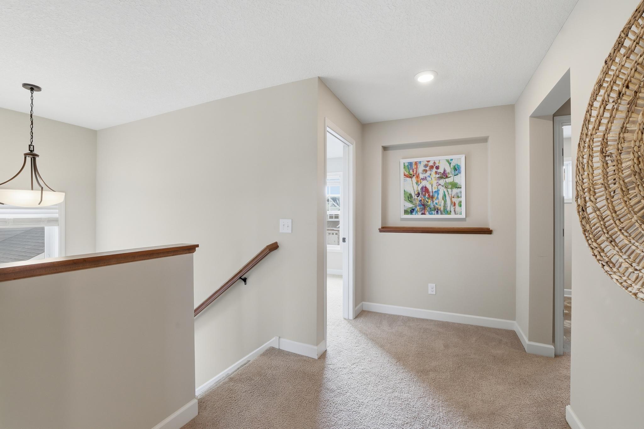 Lovely light-filled landing leading to bedrooms, laundry room and walk-in linen closet.