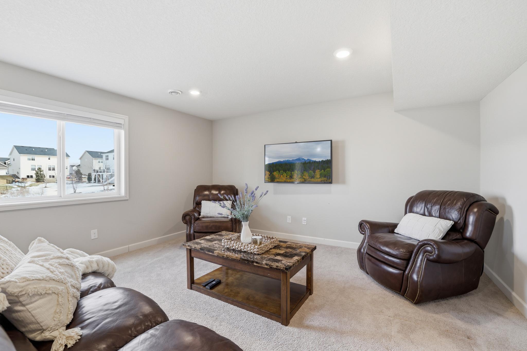 Heading downstairs is a finished entertainment room.