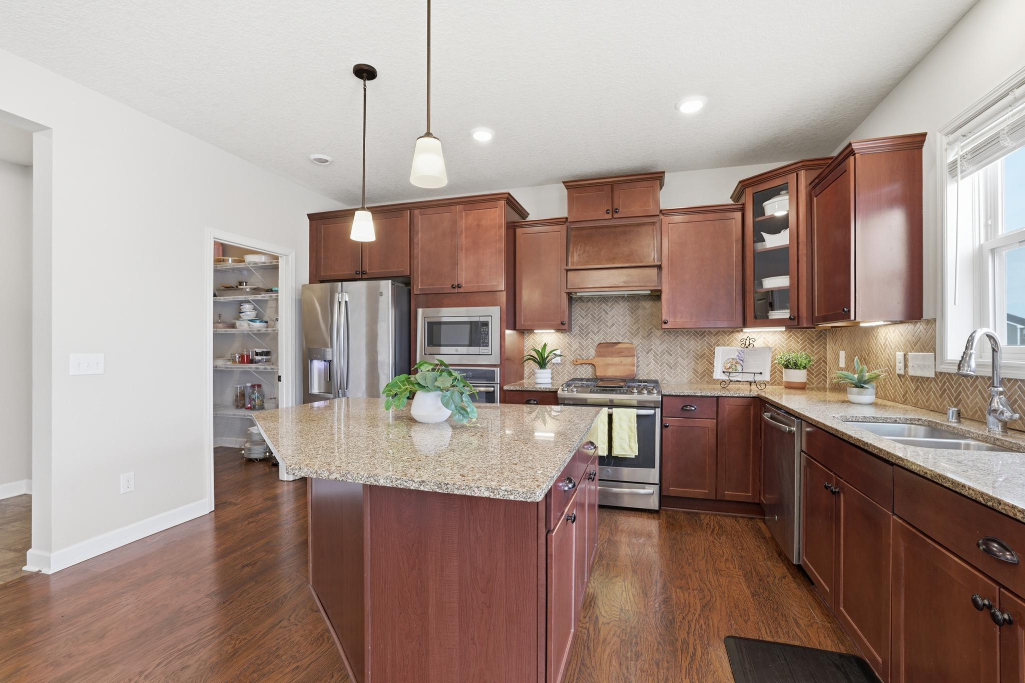 Plenty of cabinets and large walk-in pantry
