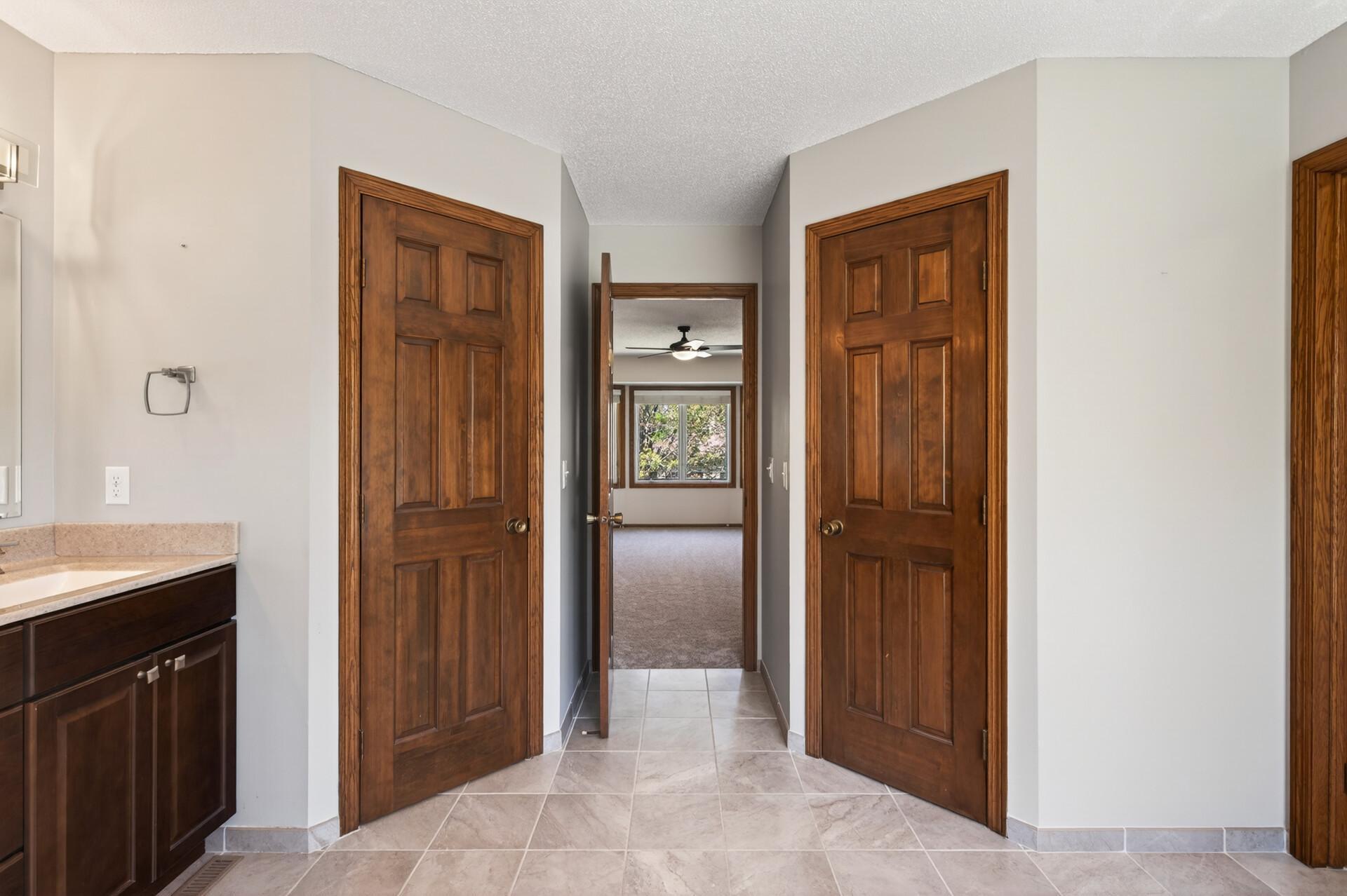 "His and Hers" closets in the primary bathroom.
