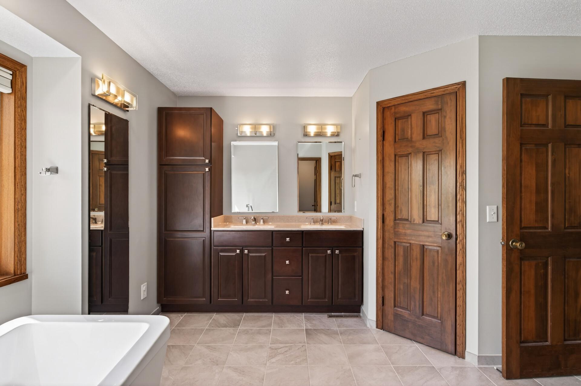 Lovely tiled flooring and dual vanity sinks.