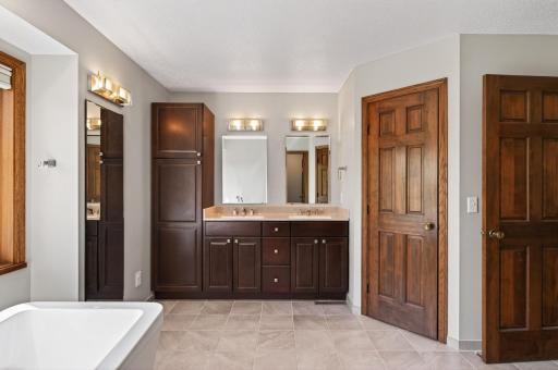 Lovely tiled flooring and dual vanity sinks.