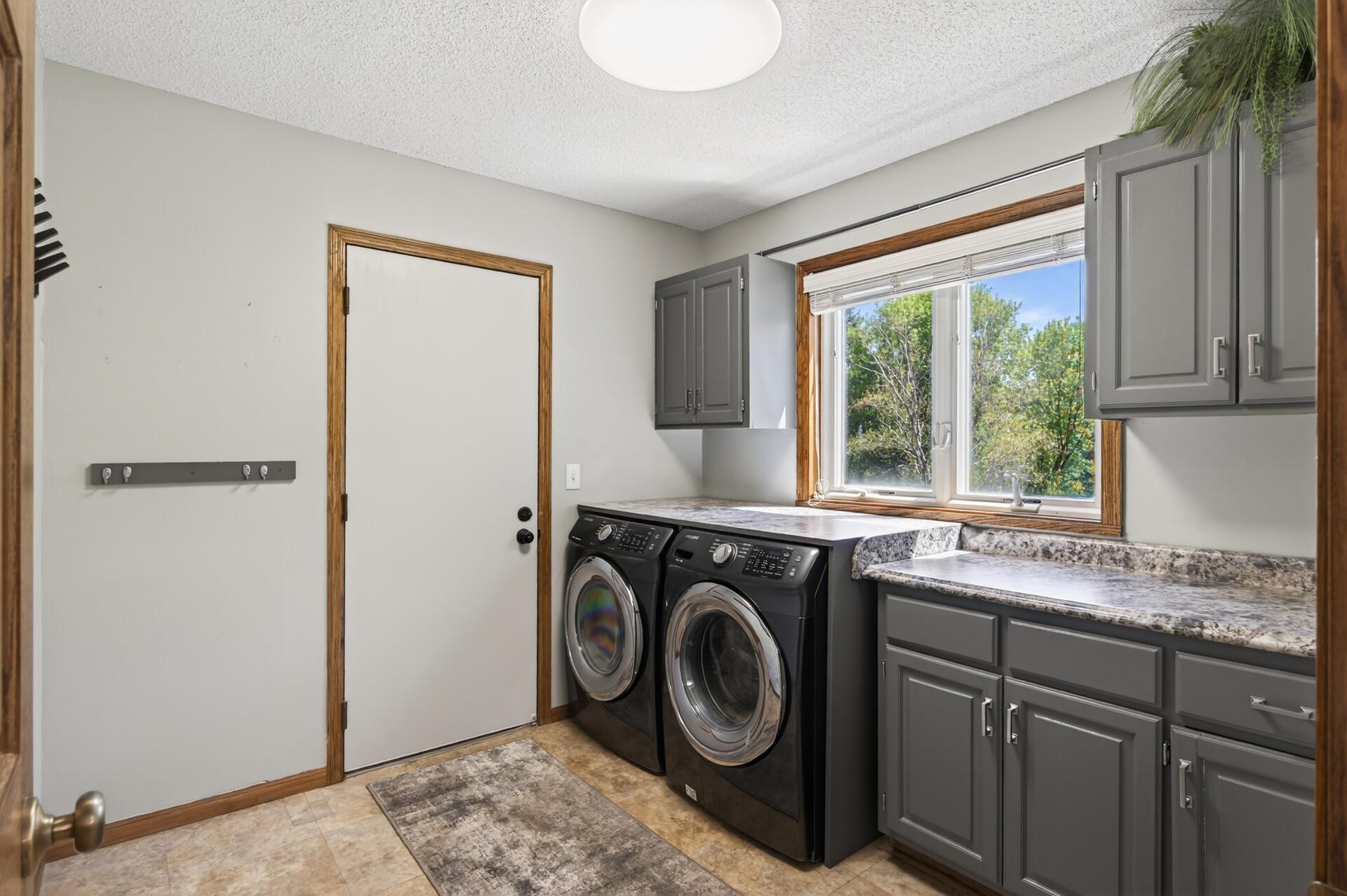 Main floor laundry & mud room right off of the garage. Counterspace next to the washer/dryer has hookups for a sink!