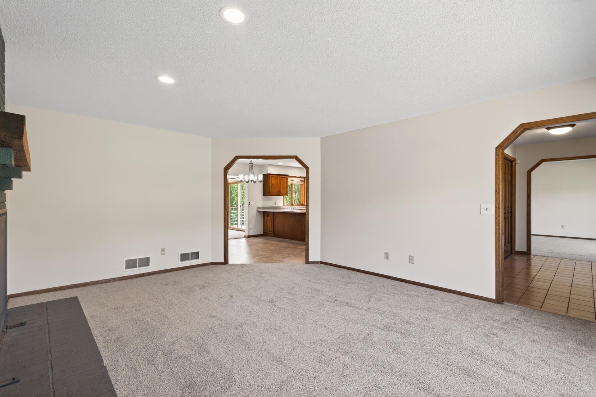 Fireplace living room leads to kitchen.
