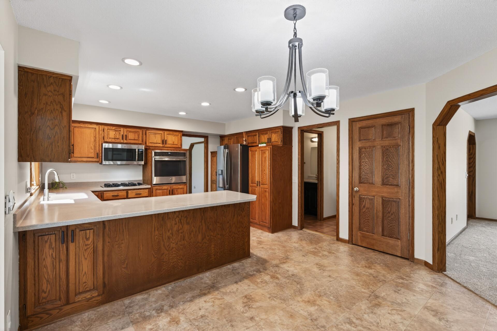 Spacious kitchen with plenty of cabinet space and SS appliances.