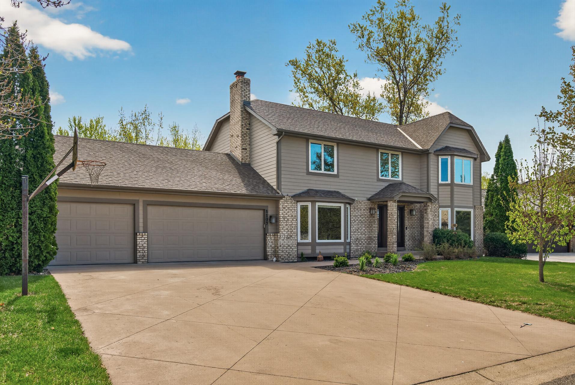 Beautifully maintained home with large concrete driveway and 3-stall garage.