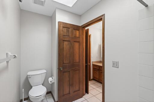 Full bathroom in upper level hallway has another room with the toilet and bath/shower.
