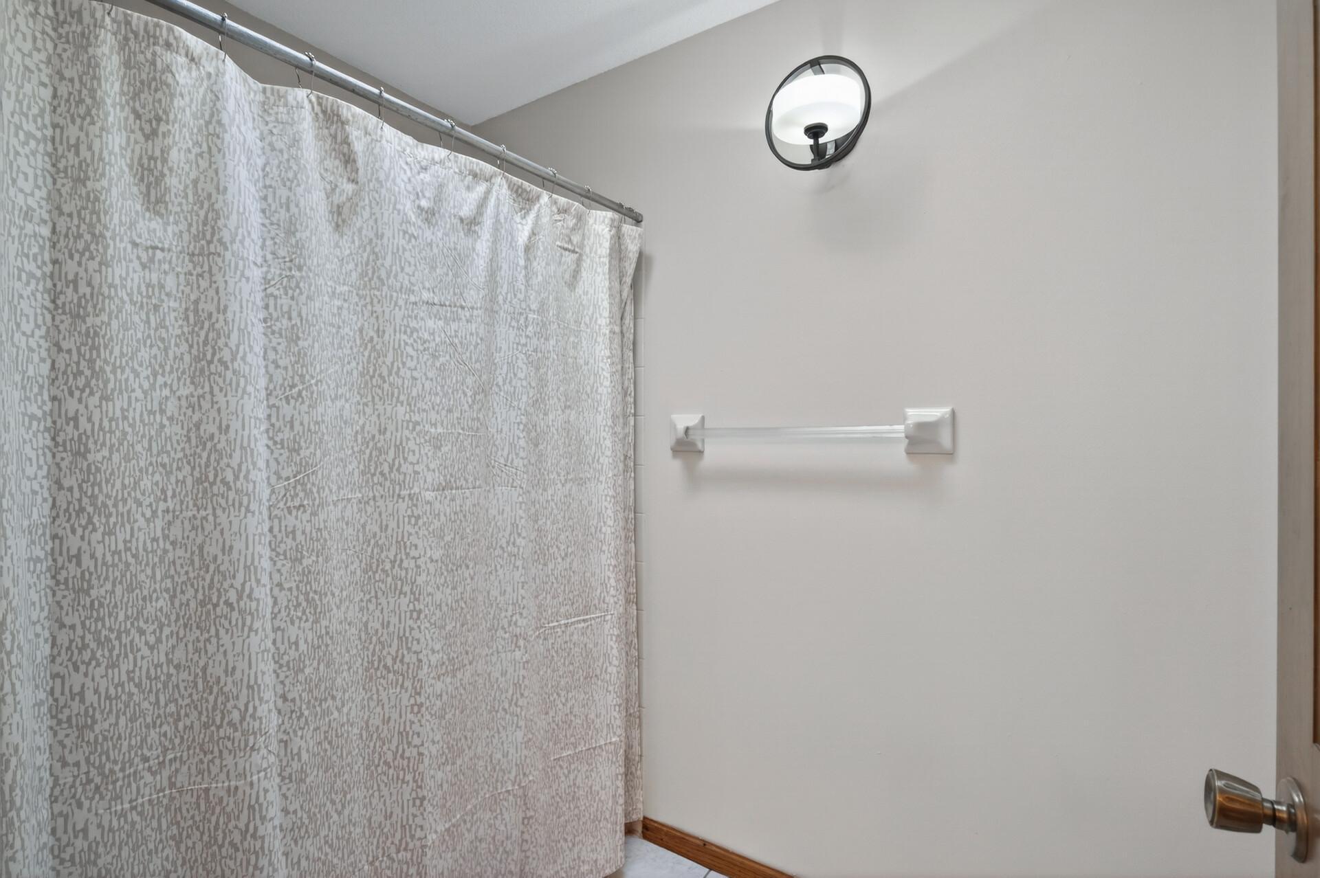 Full bathroom in upper level hallway has another room with the toilet and bath/shower.