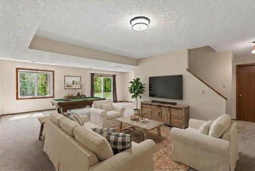 Virutally staged lower level family room.