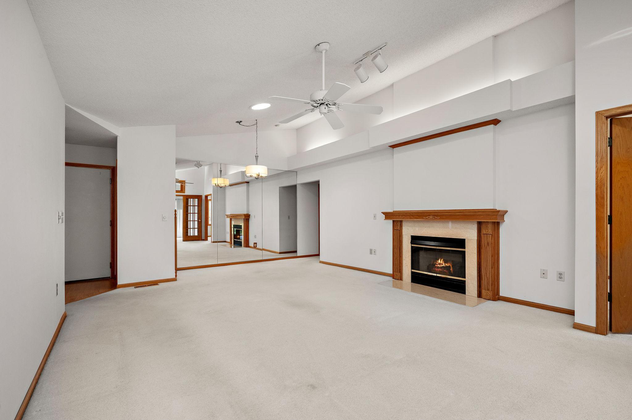 You’ll love the vaulted ceilings in the living room, anchored by a cozy gas fireplace with a marble surround and enhanced by solar tubes that bathe the space in natural light