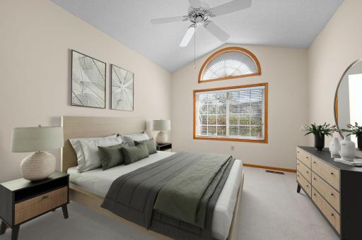 Primary Suite: A spacious retreat with vaulted ceilings, a walk-in closet, and a private full bath equipped with a jetted tub, separate shower, and natural solar tube lighting