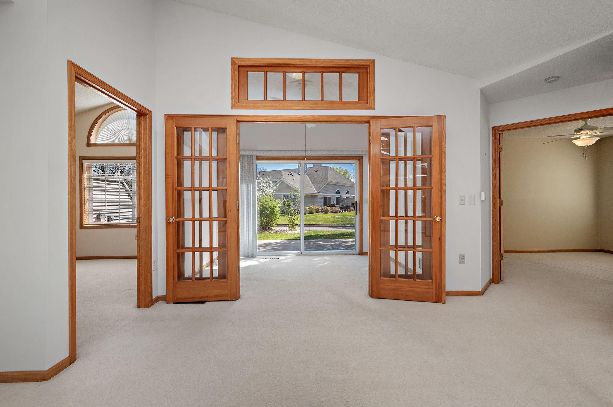 Relax in the vaulted sunroom featuring elegant French doors and direct access to your private patio