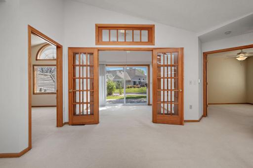 Relax in the vaulted sunroom featuring elegant French doors and direct access to your private patio