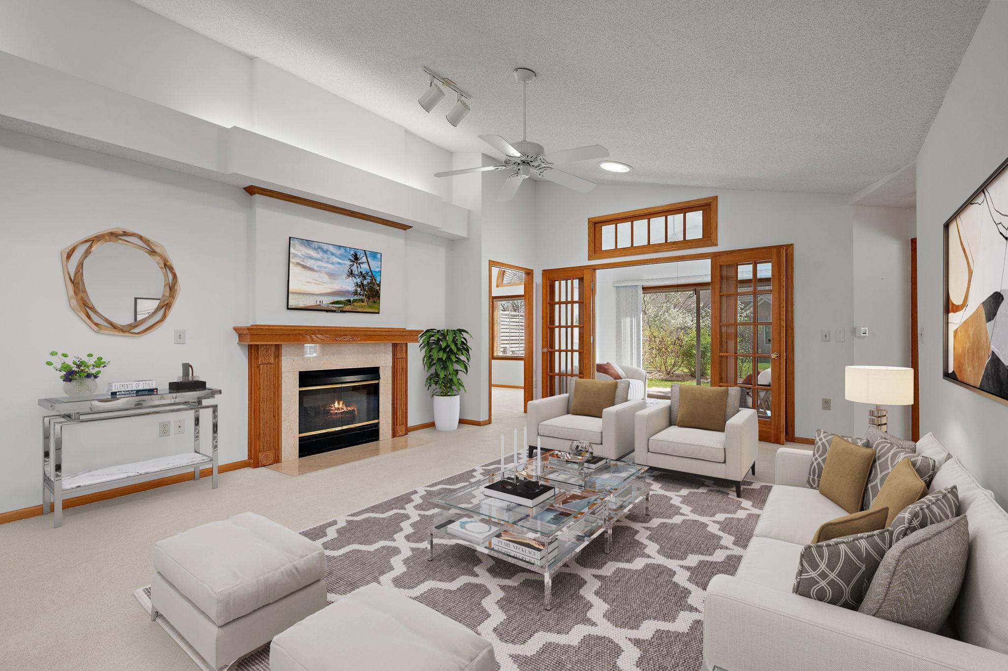 You’ll love the vaulted ceilings in the living room, anchored by a cozy gas fireplace with a marble surround and enhanced by solar tubes that bathe the space in natural light