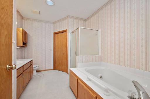 Primary Suite has a private full bath equipped with a jetted tub and separate shower