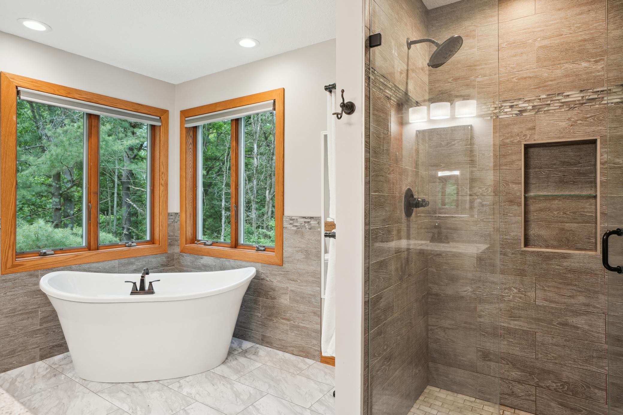 Beautifully updated ensuite bath offering a luxury soaking tub and walk-in shower.jpg