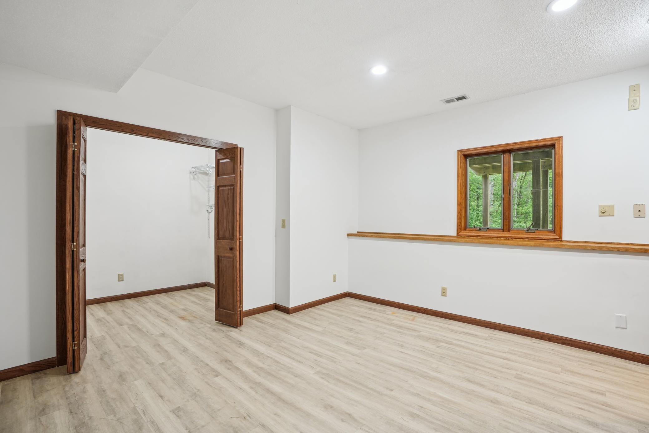 Large lower-level bedroom #4 with walk-in closet and flexible living space.jpg