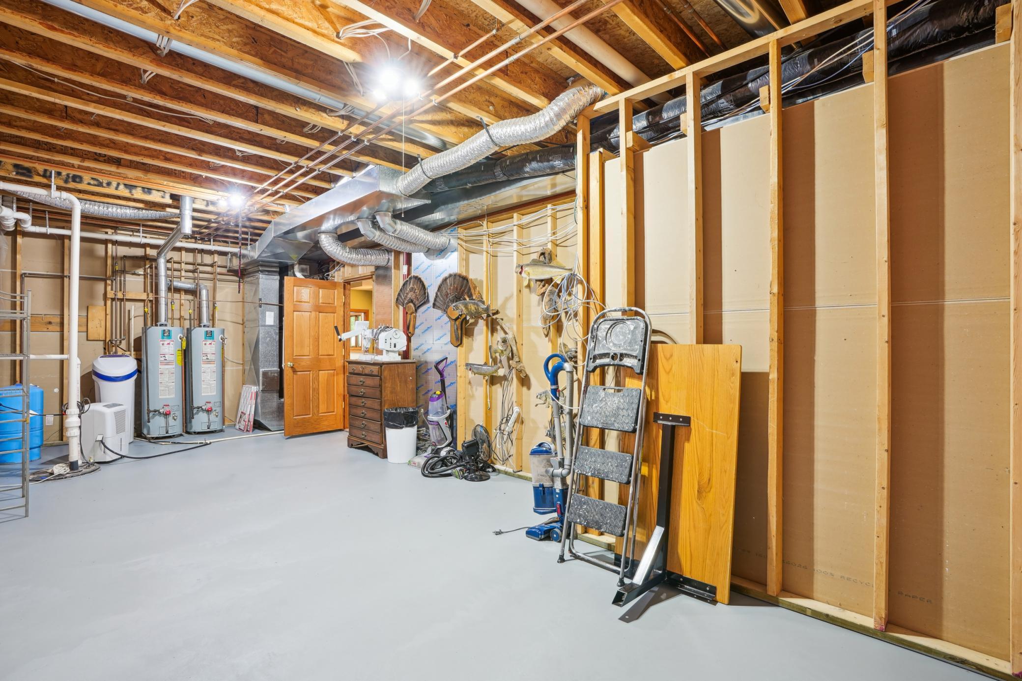 Dedicated mechanical room featuring dual hot water heaters and a water softener for added efficiency and convenience.jpg