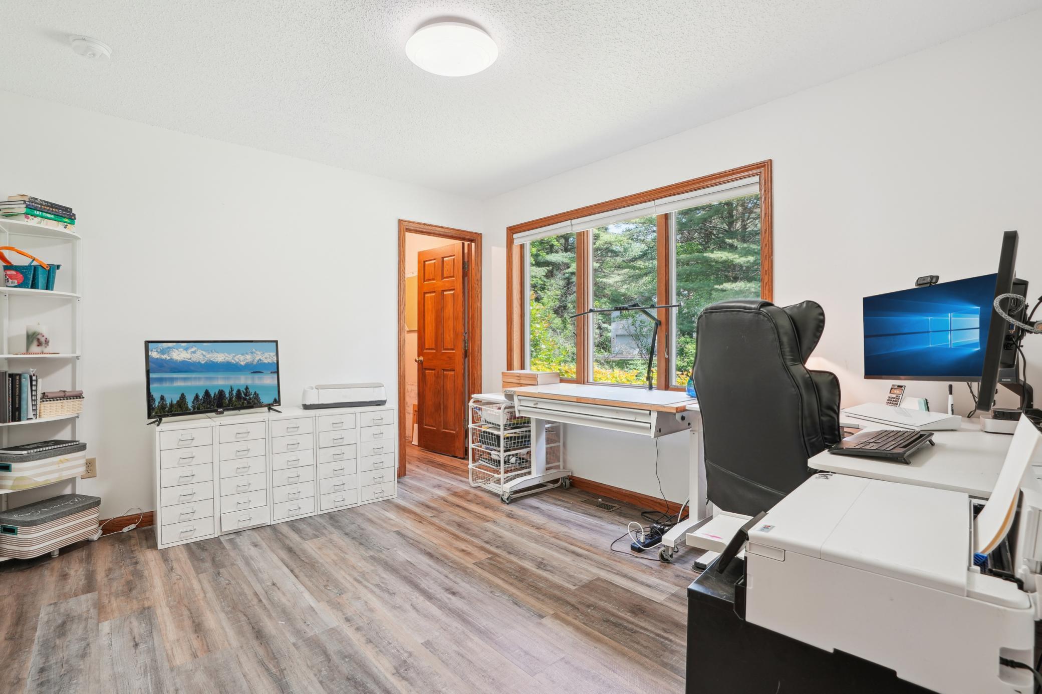 Main floor bedroom featuring a walk-in closet and versatile layout suitable for guests or home office use.jpg