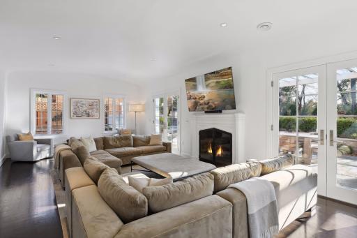 South facing Living room with french doors to terrace, flanking fireplace