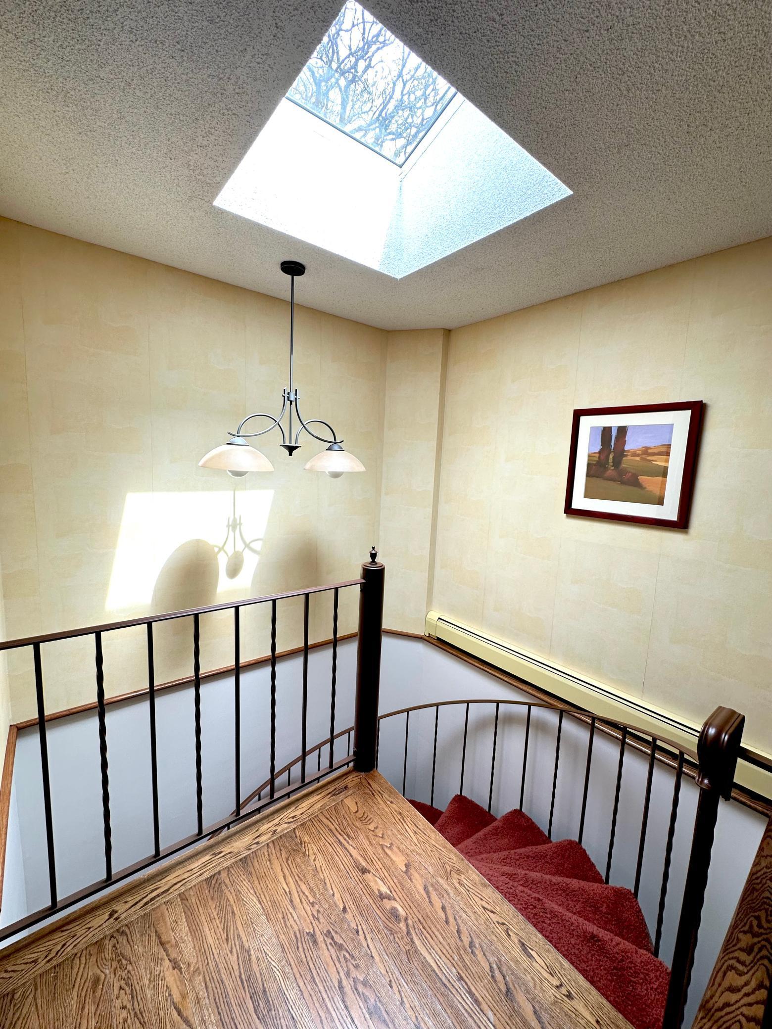 Beautiful skylights and wrap around stairs to the lower level