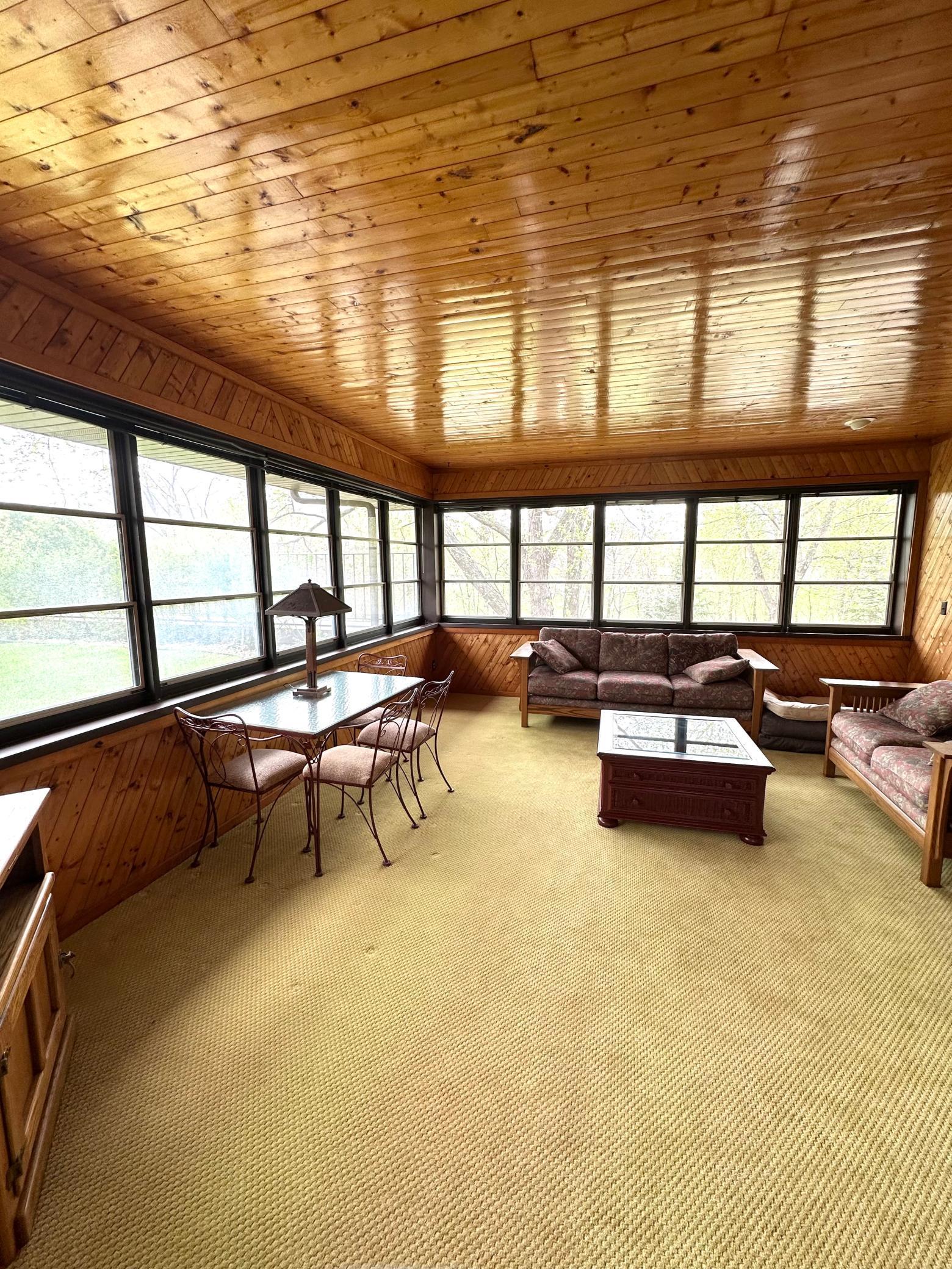 Huge 18'x16' three season porch on the main level over looking Sand Creek and lots of nature