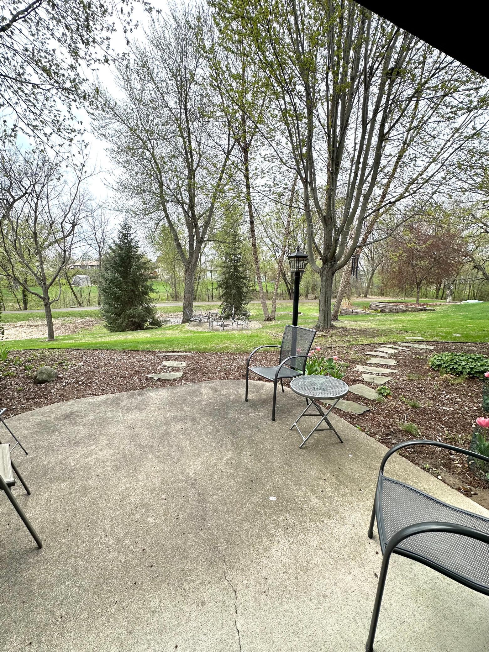 Concrete patio out back with access to Sand Creek trails
