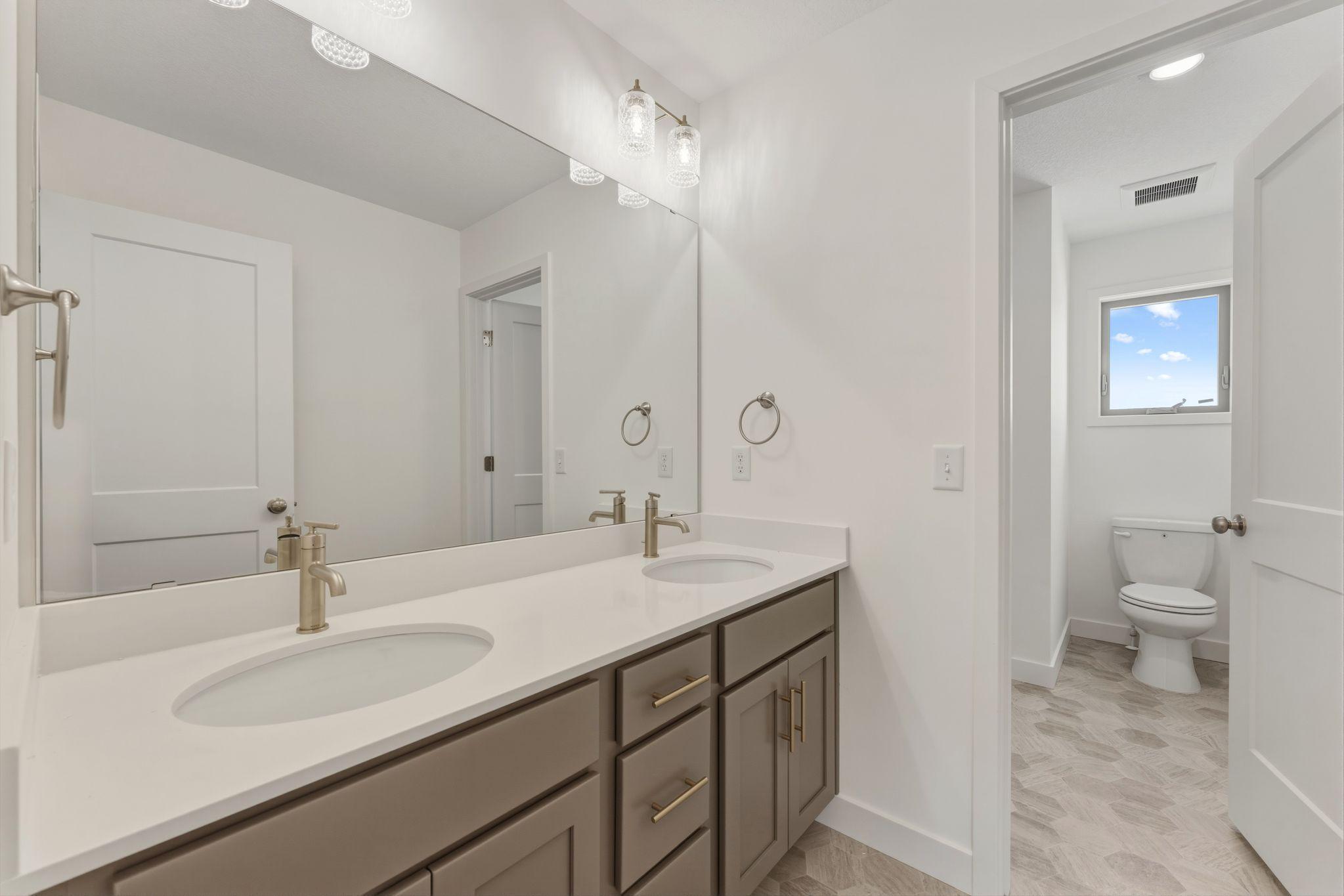 Upper level hall bath. tub and toilet are separated from vanities