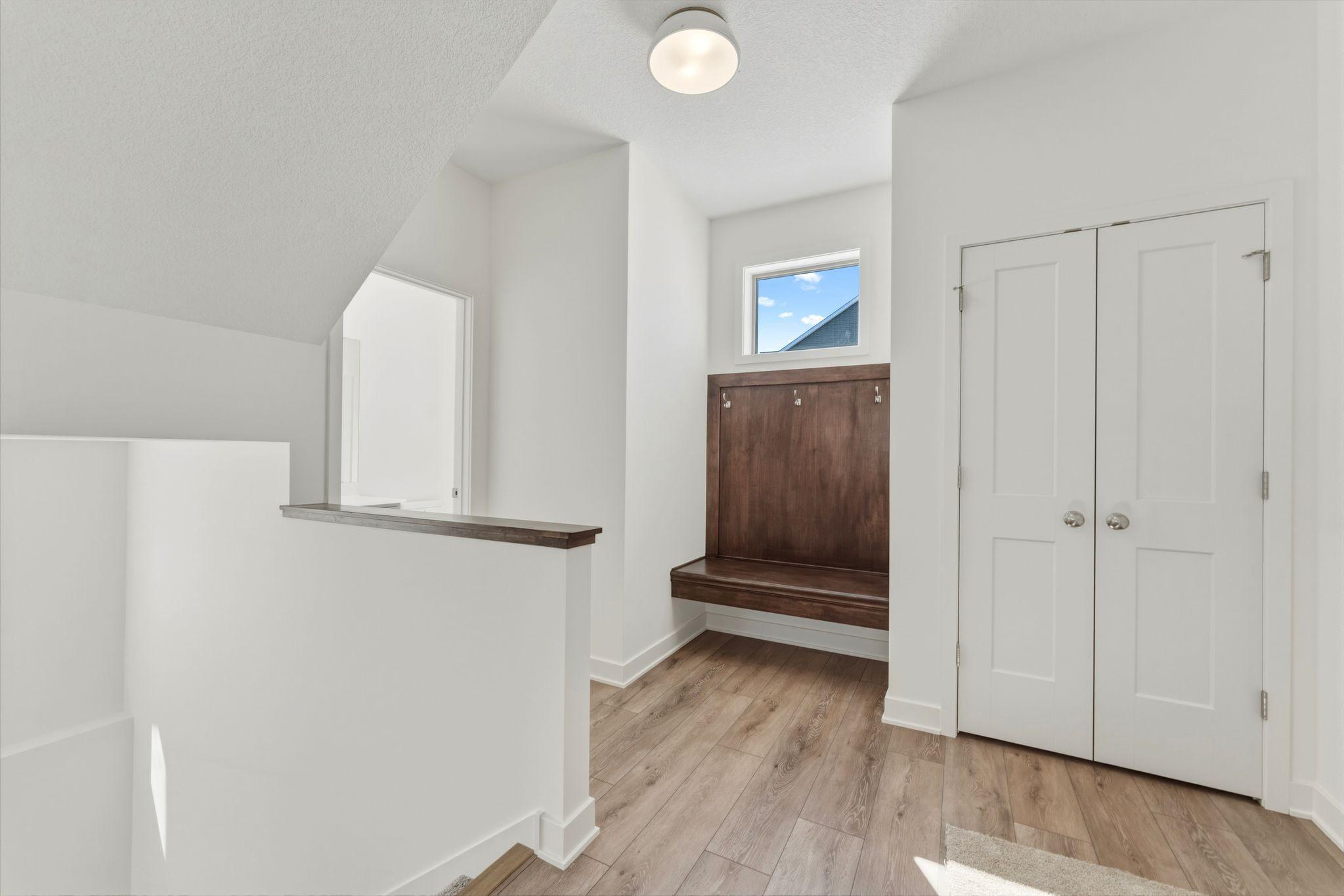 Mudroom has closet and built-in bench