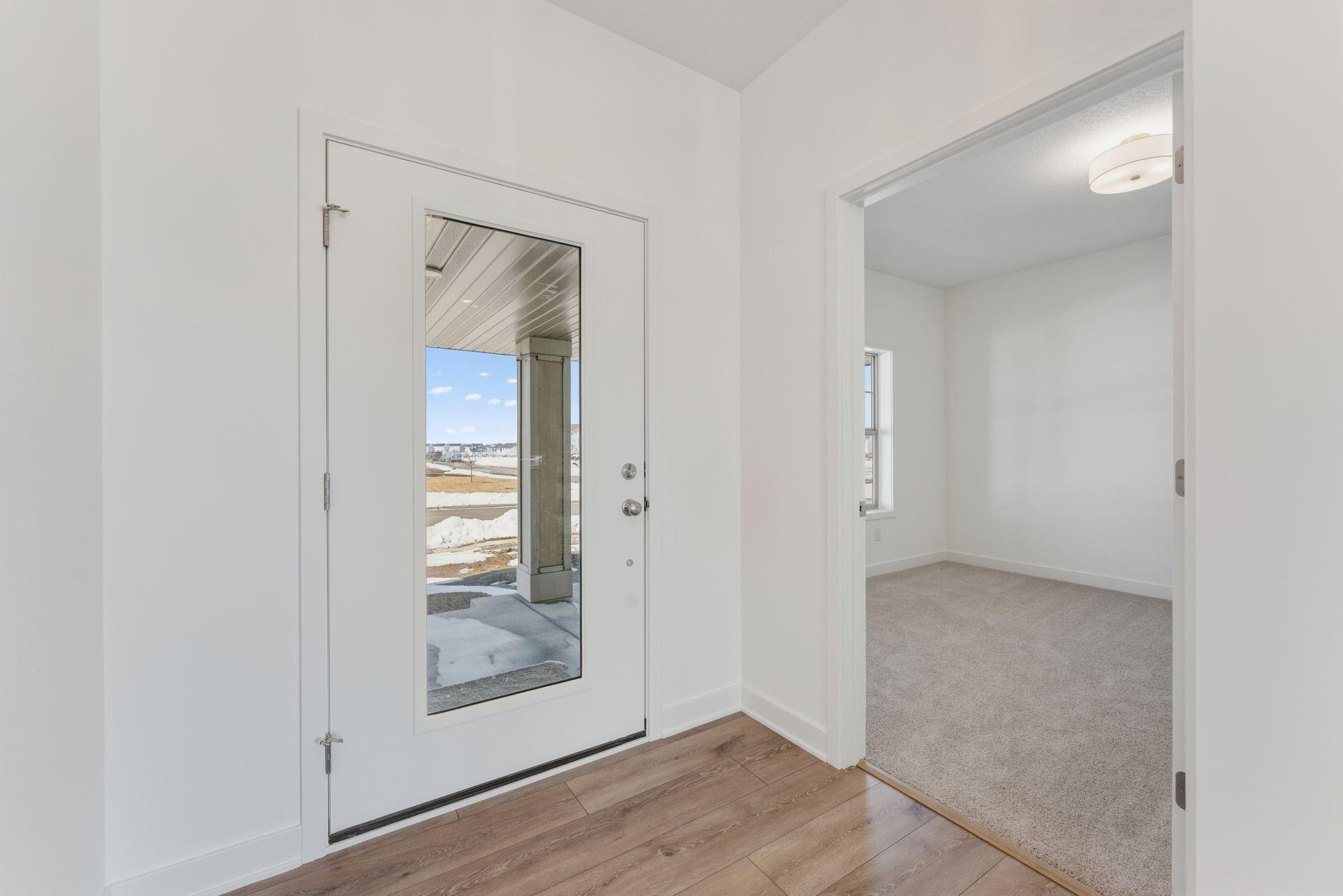 Glass front door letting in light to the foyer