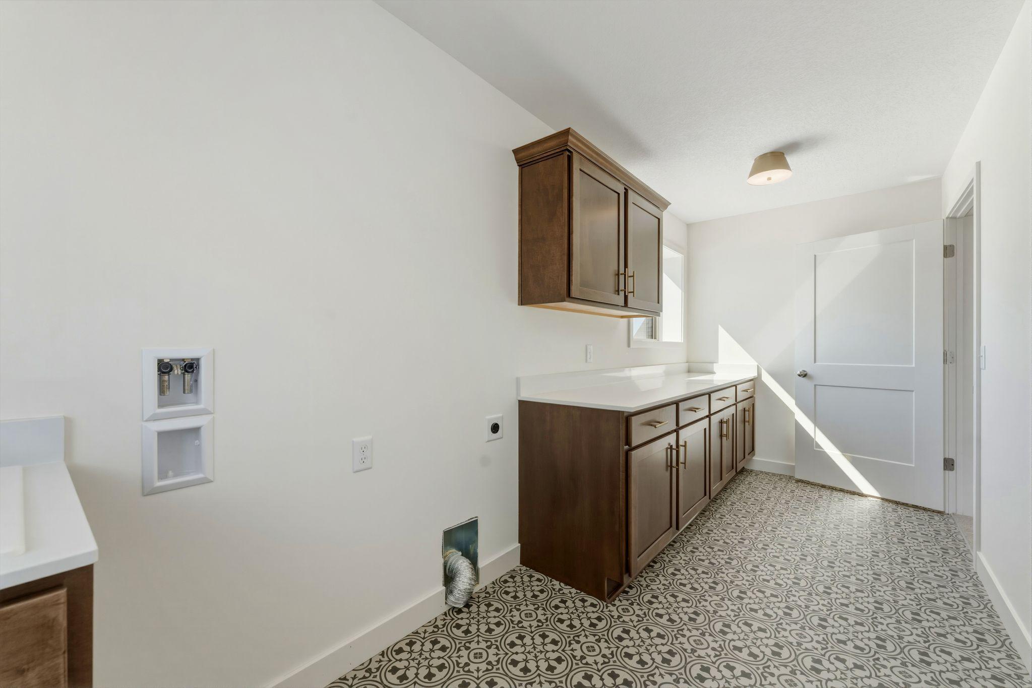 Laundry room has connections for washer and electric dryer