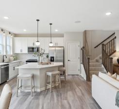 A truly one-of-a-kind kitchen island is the center piece of this kitchen. Equally beautiful and functional. This island is sure to impress while allowing for any undertaking in the kitchen! Photo of model home.