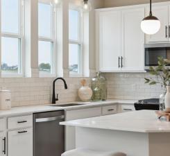 Kitchen comes with modern stainless steel appliances providing both functionality and style. Photo of model home.