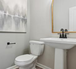 Main level also features a luxurious half bath tucked away by the entrance from your front door! Photo of model home.