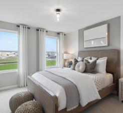 Spacious guest bedrooms are perfect for any use! Photo of model home.