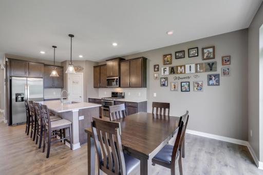 Large center island, corner pantry, and stainless steel appliances