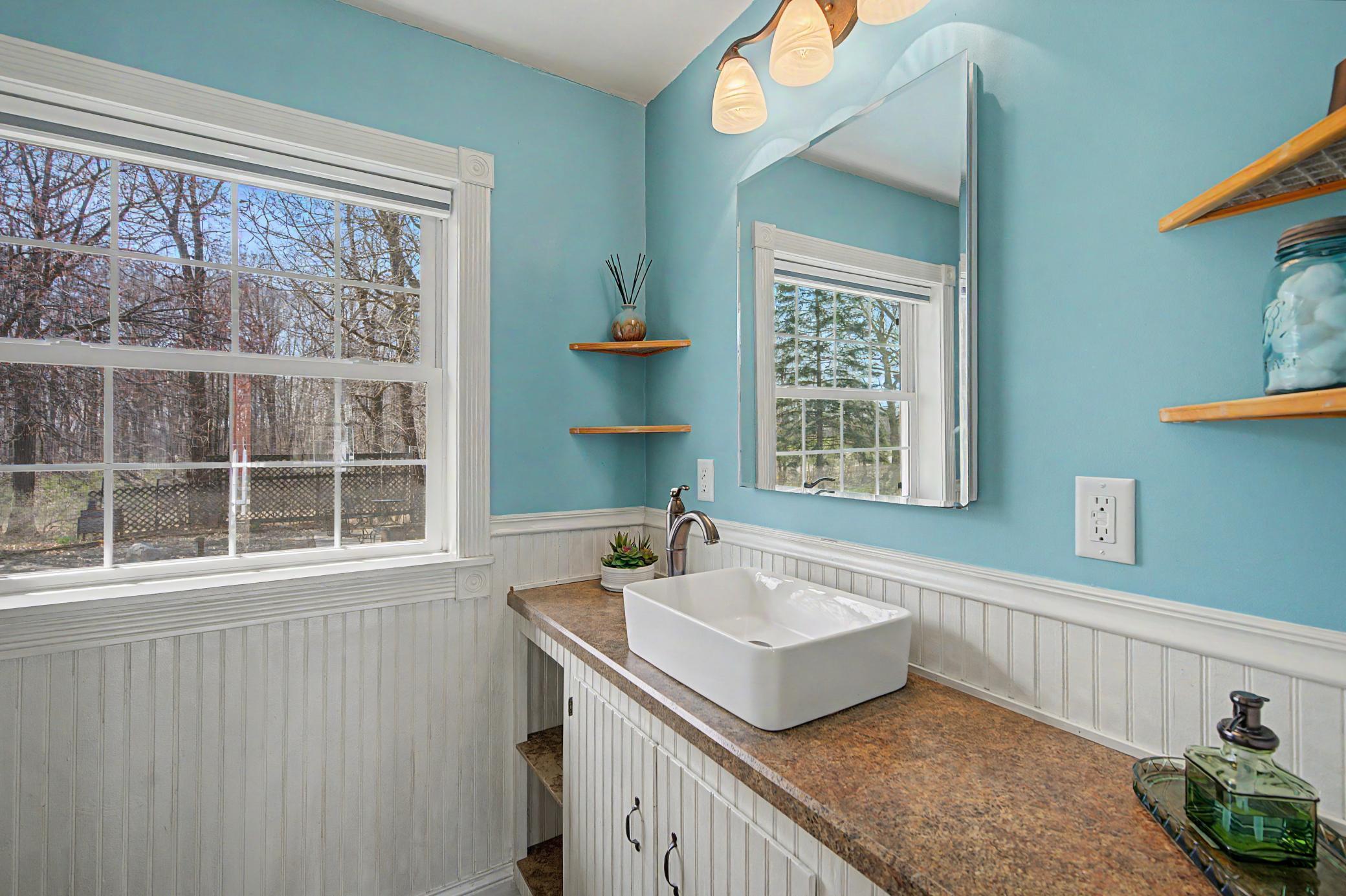 Main level 3/4 bathroom with a walk in shower